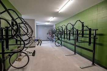 A bike rack with many bicycles parked in it.